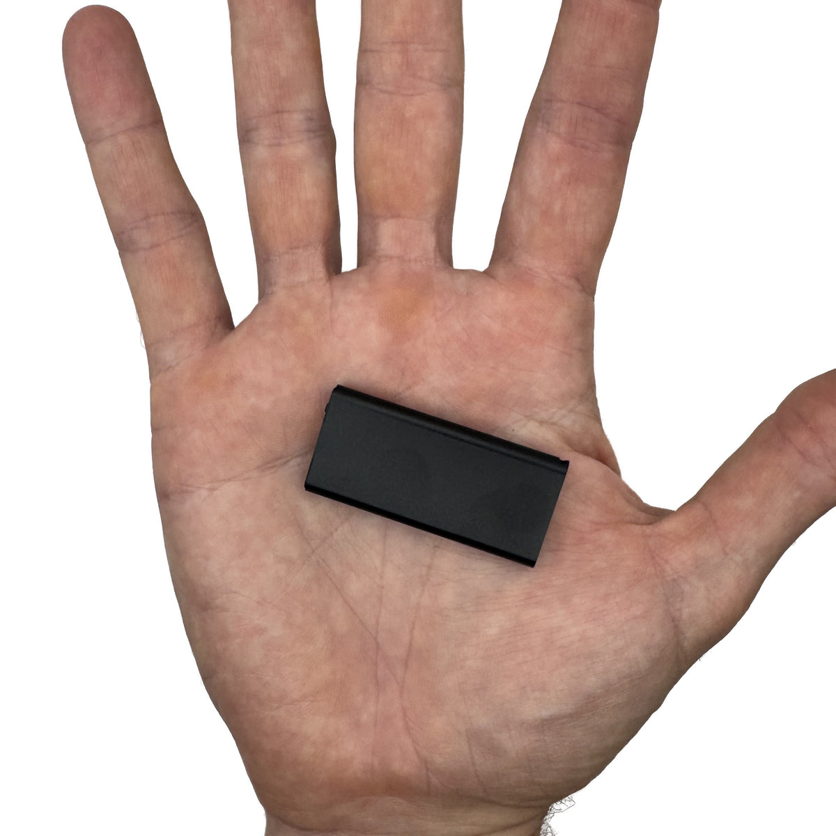 Mini voice activated recorder in the palm of a hand for scale