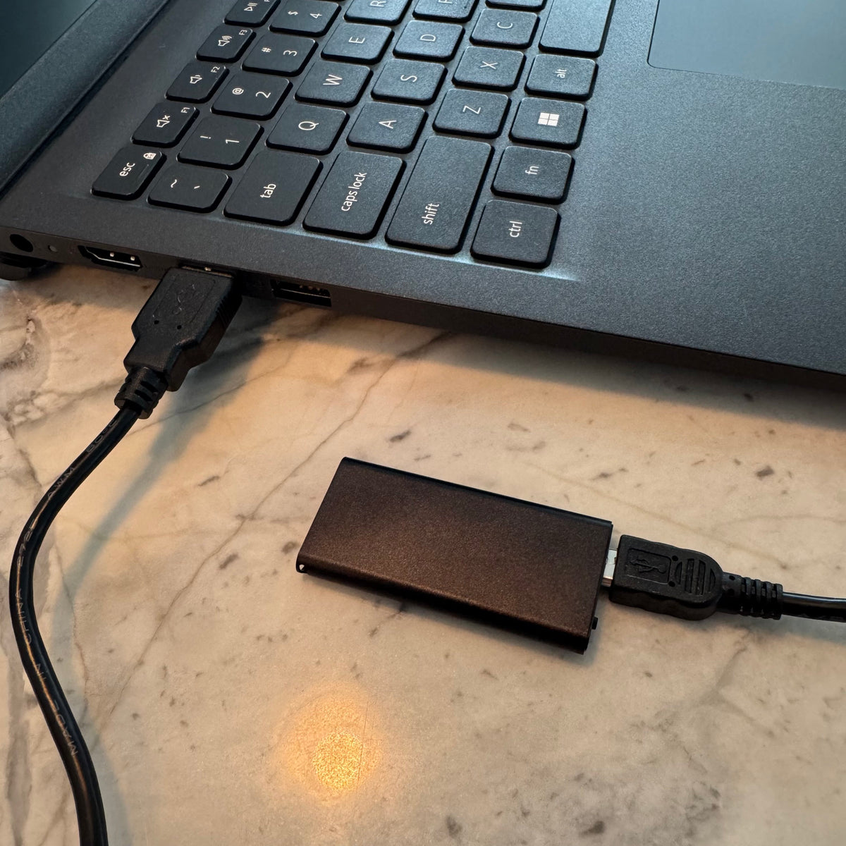 Micro voice recorder connected to a Windows laptop by USB