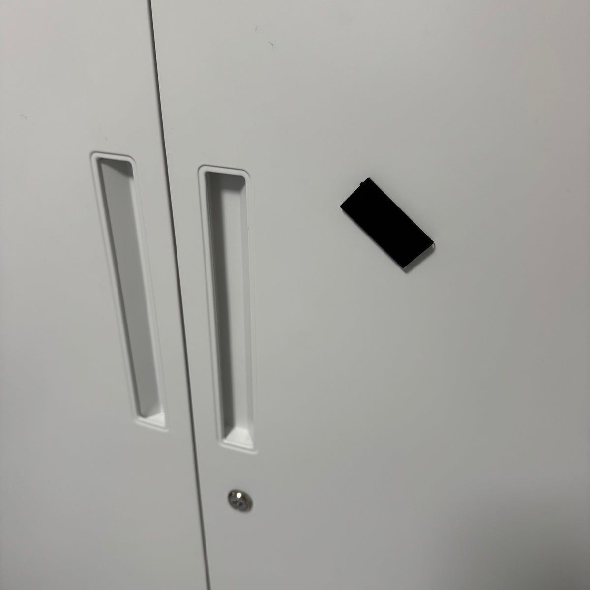 Magnetic micro voice recorder attached to a metal cabinet