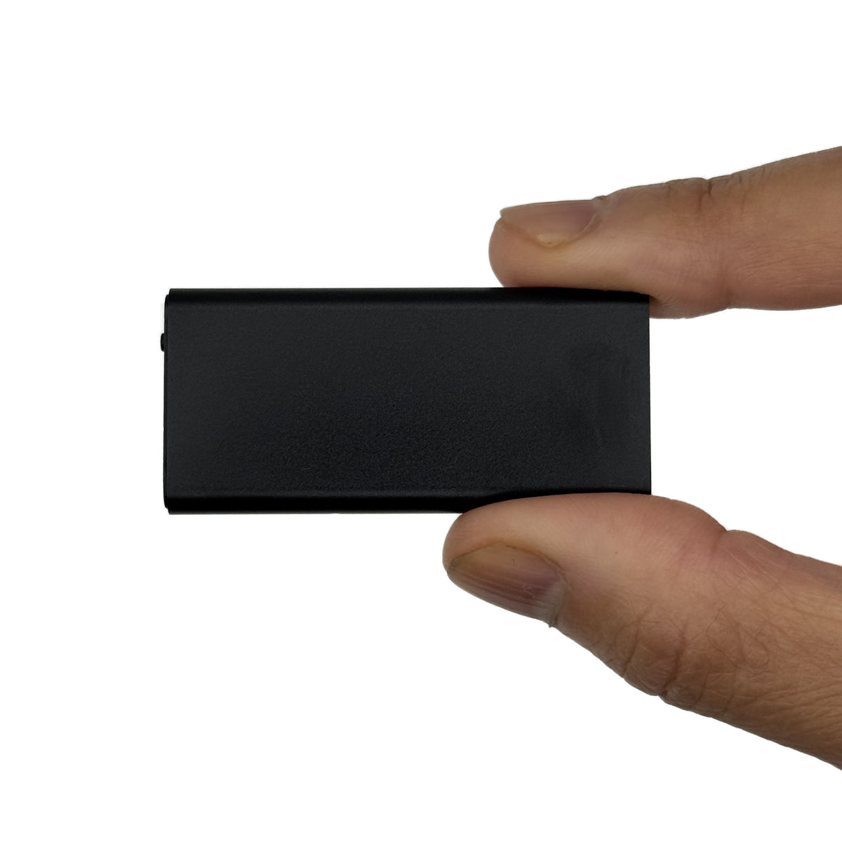 Small voice activated recorder held in hand, front view
